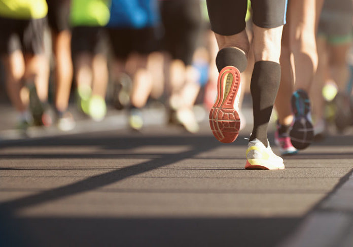 Marathon running in the light of evening, detail on legs